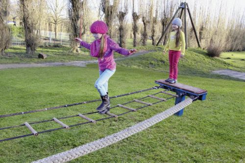 Children playing on the "tightrope walker" play equipment
